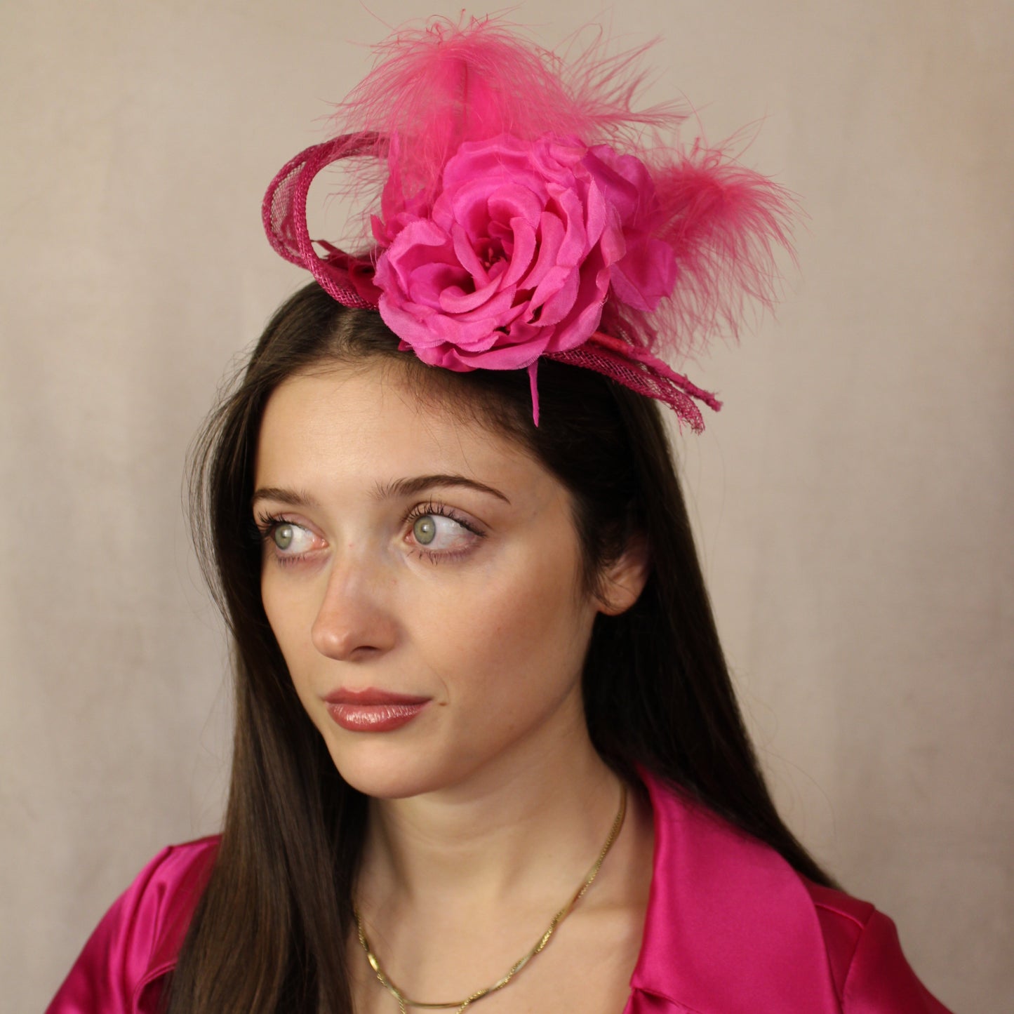 Fuchsia pink flower, feather fascinator.