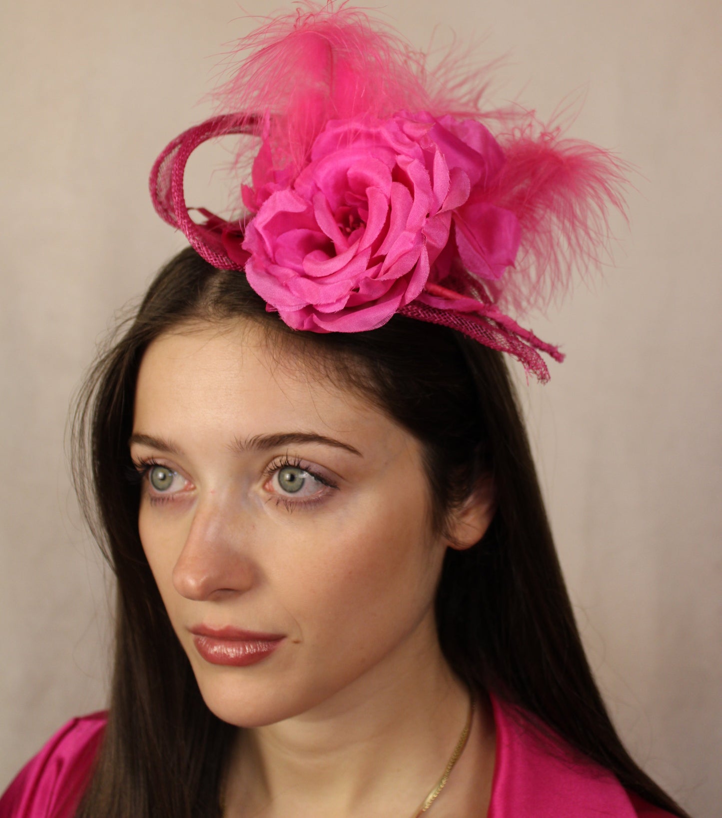 Fuchsia pink flower, feather fascinator.